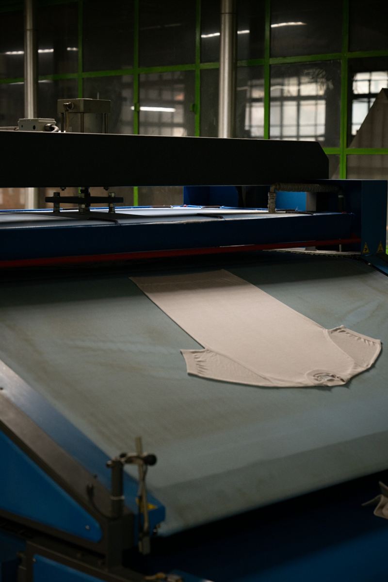 A knitted garment on the steam press table